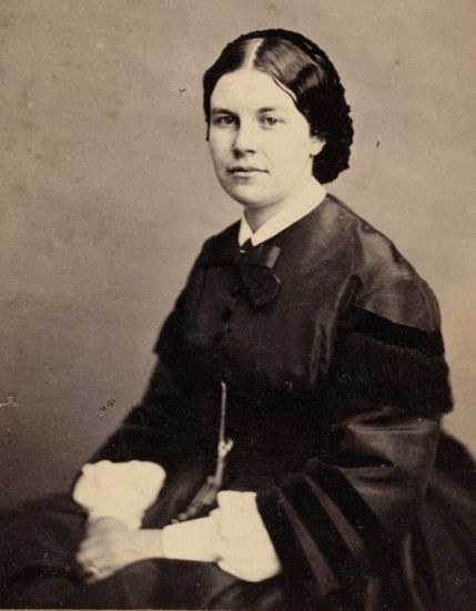 Annie Shaw, a young woman in 1860s dress, in mourning.