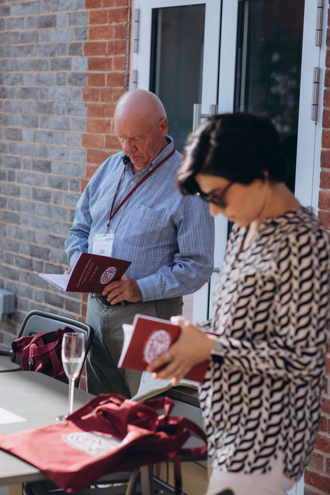 Two historians looking at programmes for the Skilliter Centre conference