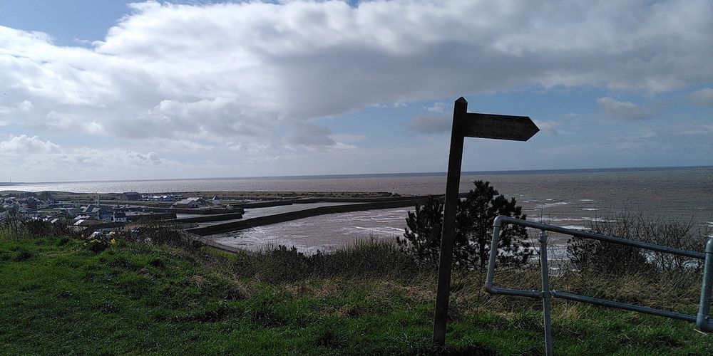 View of Maryport close to the former Roman Fort including signpost for England Coastal Path