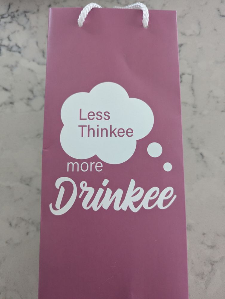 A tall booze bottle gift bag with the words "Less thinkee, more drinkee" on the side.