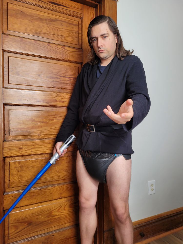 Blankey shows off his Anakin Skywalker costume with a black robe and blue lightsaber. Looks like he forgot to put his pants on though, and his black diaper is out on display