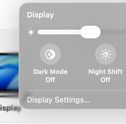 Display settings on MacOS 26, in Apple's new "Liquid Glass" style. Text is white on a gray background.