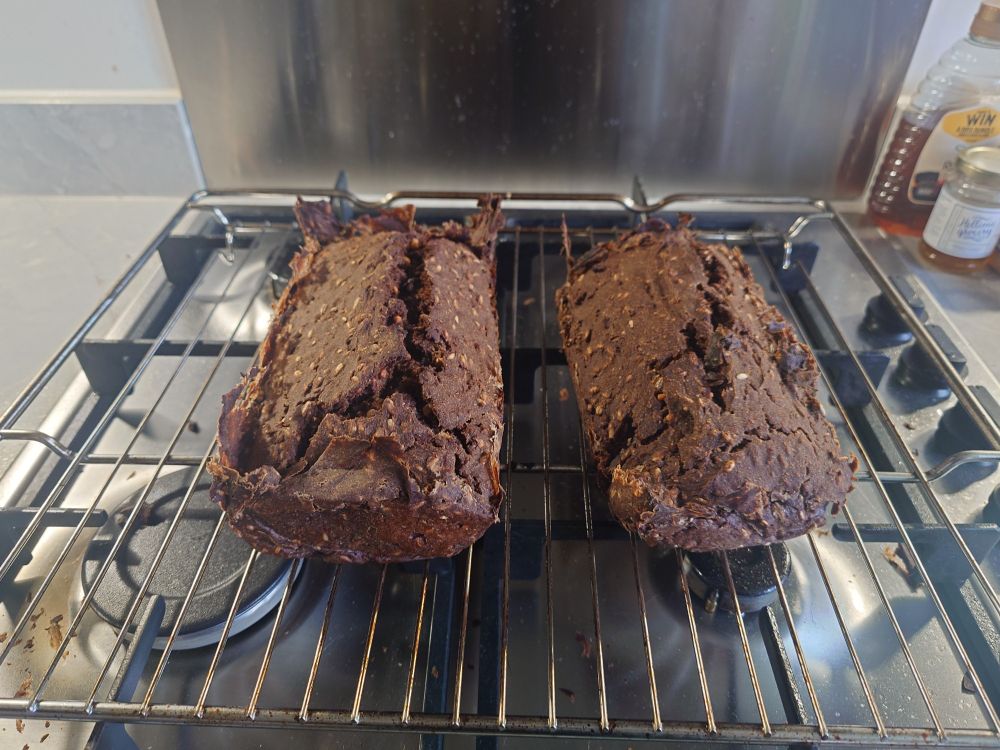 2 loaf of rye bread cooling on the rack