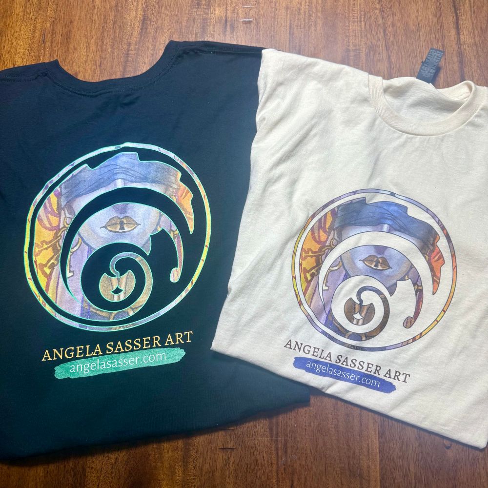 Black and white tshirts with a test color logo on them for AngelaSasserArt, my Fantasy Illustration brand. Good quality fabric and clear printing. Shirt labels are also brand-able!