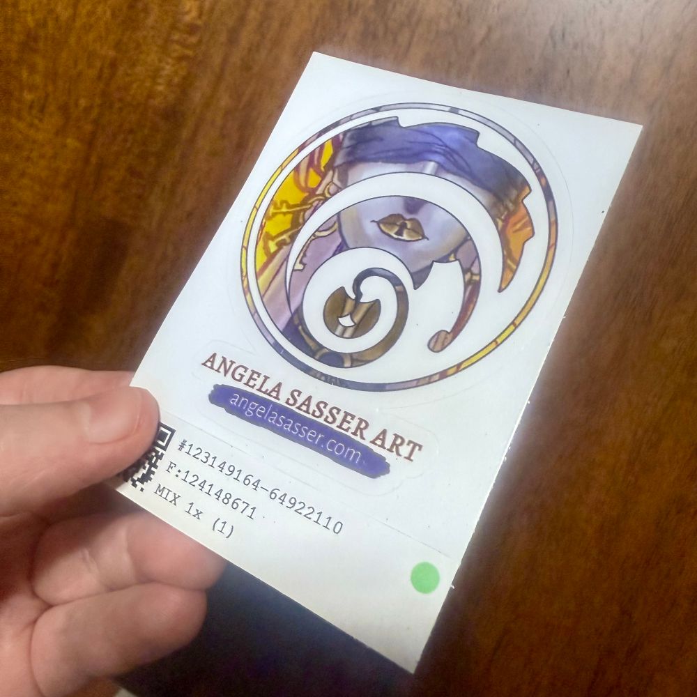 A kiss cut sticker of the AngelaSasserArt logo. Clear printing, good color quality, and consistent vignette cutting.