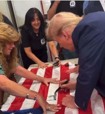 Trump desecrates flag with his signature.