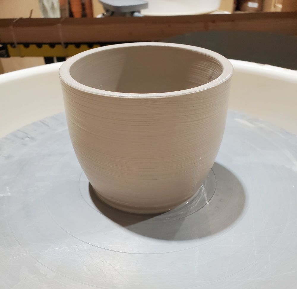 Ceramic pot on pottery wheel