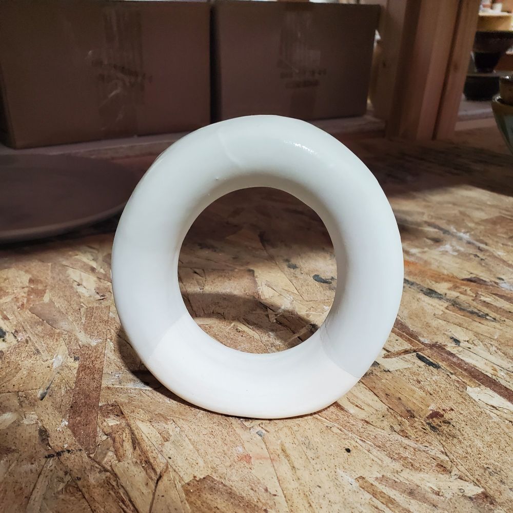 A doughnut vase dipped in glaze. 