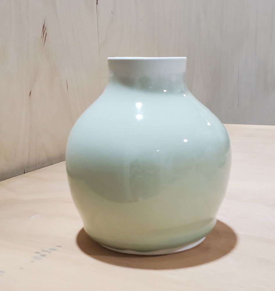 Small ceramic pot with sage green celadon glaze.