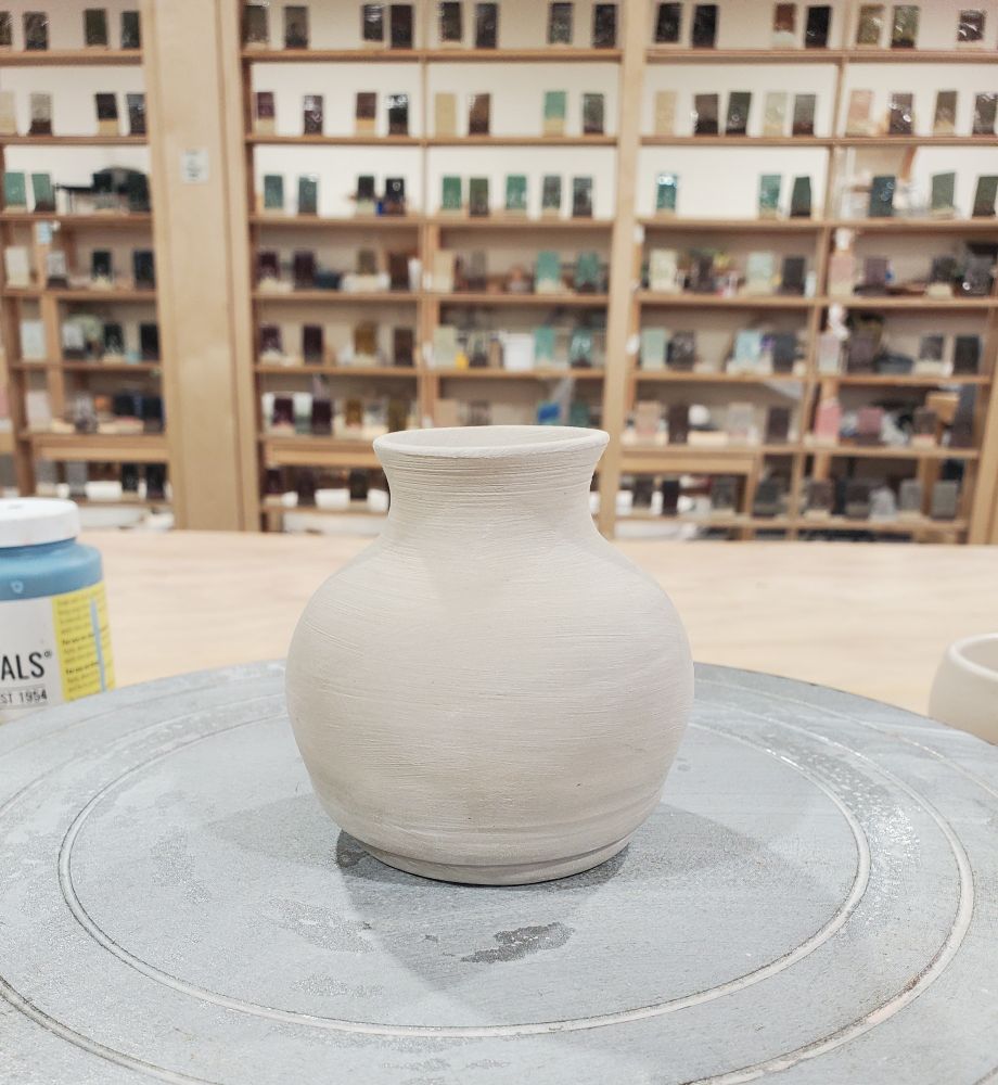 A small ceramic vase ready for underglaze.