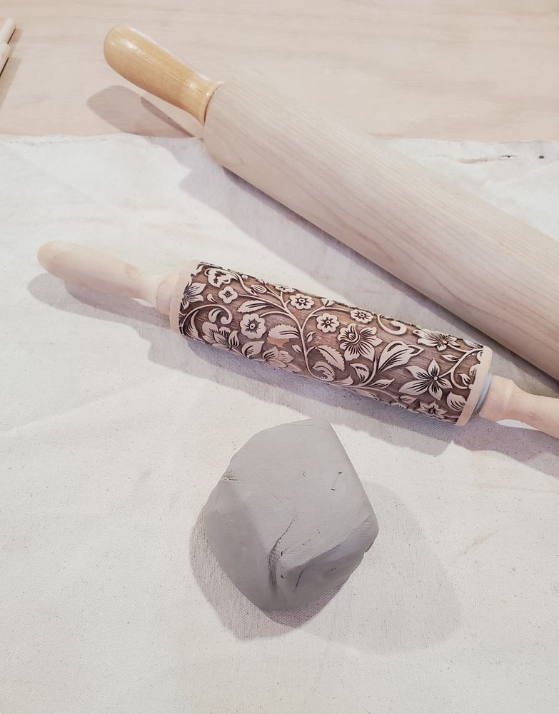 A chunk of white clay and two rolling pins.
