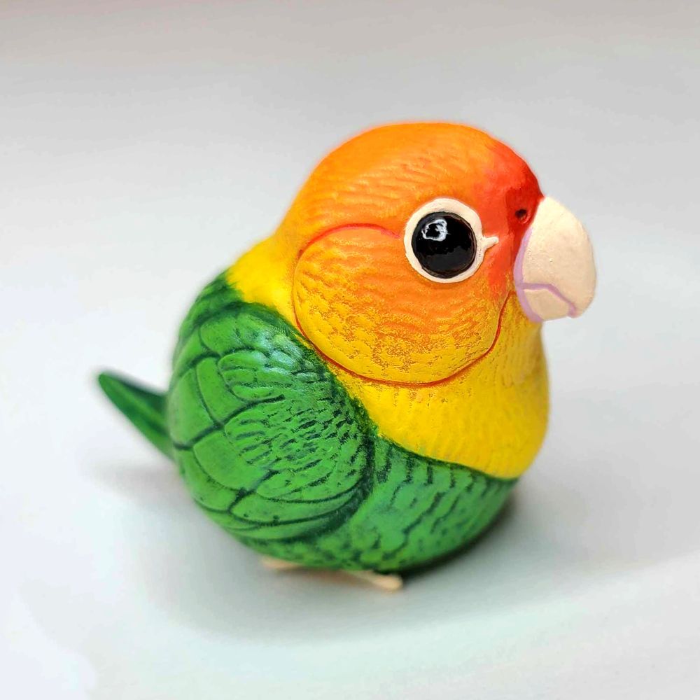 a sculpture of a Carolina Parakeet that has been made more round 