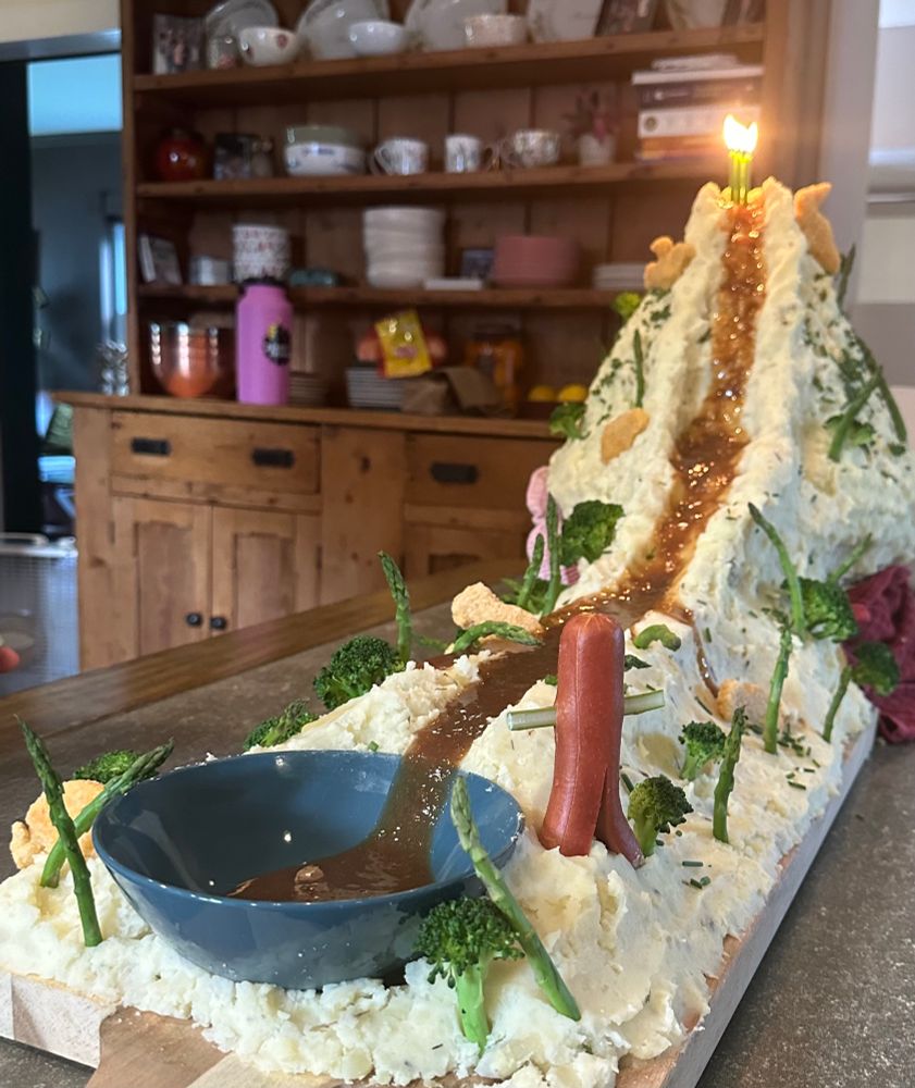 Mashed potato volcano with gravy flowing down the side 
