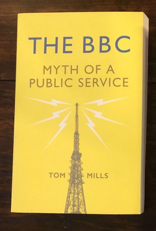 A photograph of the book, The BBC: Myth of a Public Service by Tom Mills. The cover features a radio tower beaming out signals. End ID. 
