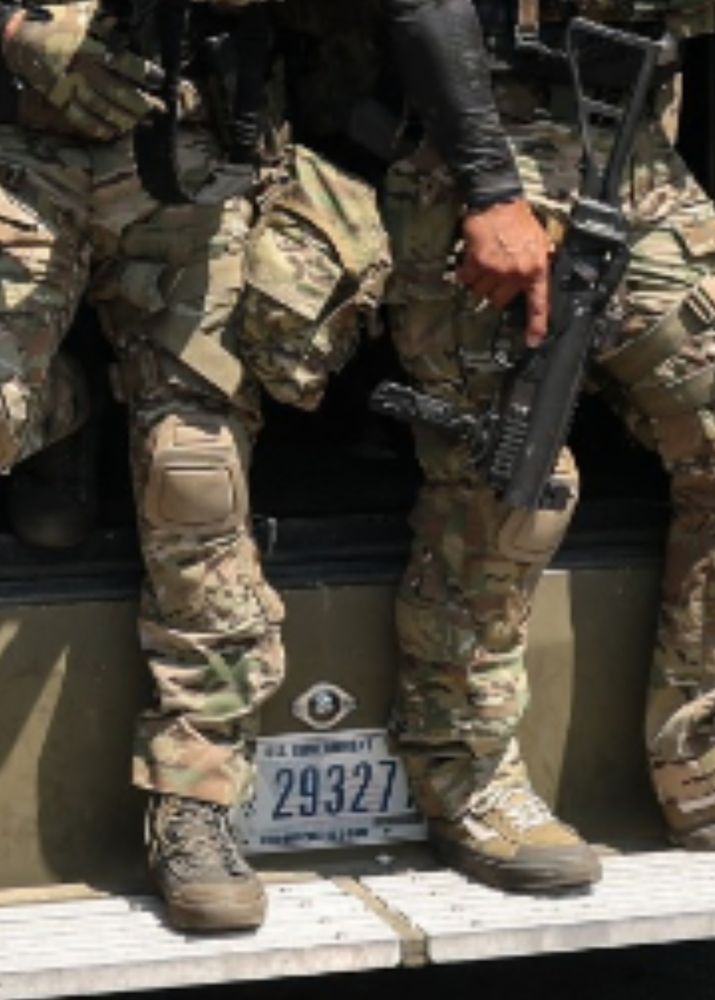 Supposed gov't. 
Why different shoes & guns drawn?