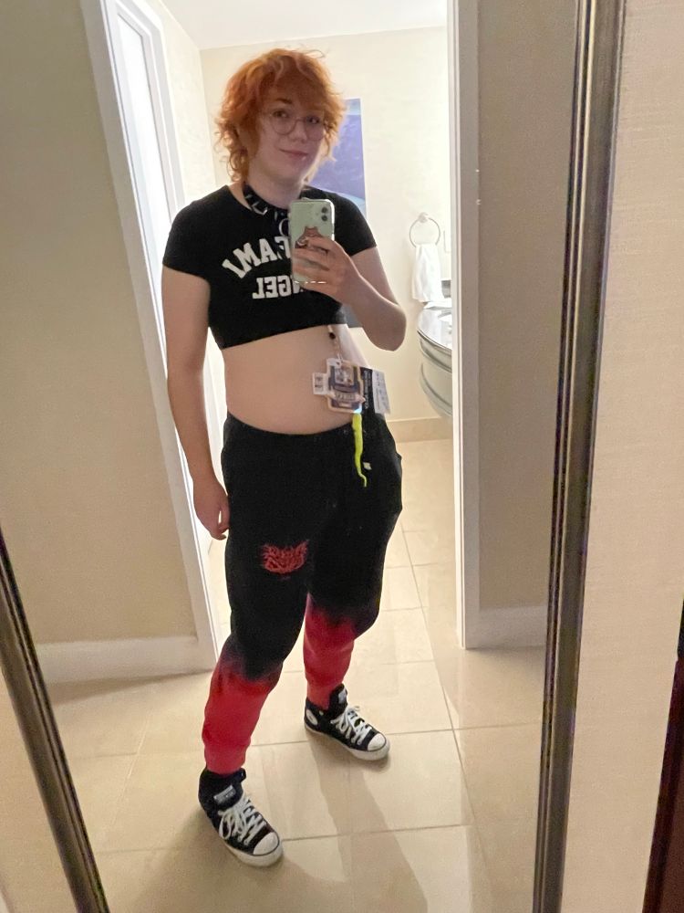 A photo of me! Im wearing a black spiked choker, a Origami Angel crop top and sweatpants from kingguro. Im also wearing my converse shoes.
