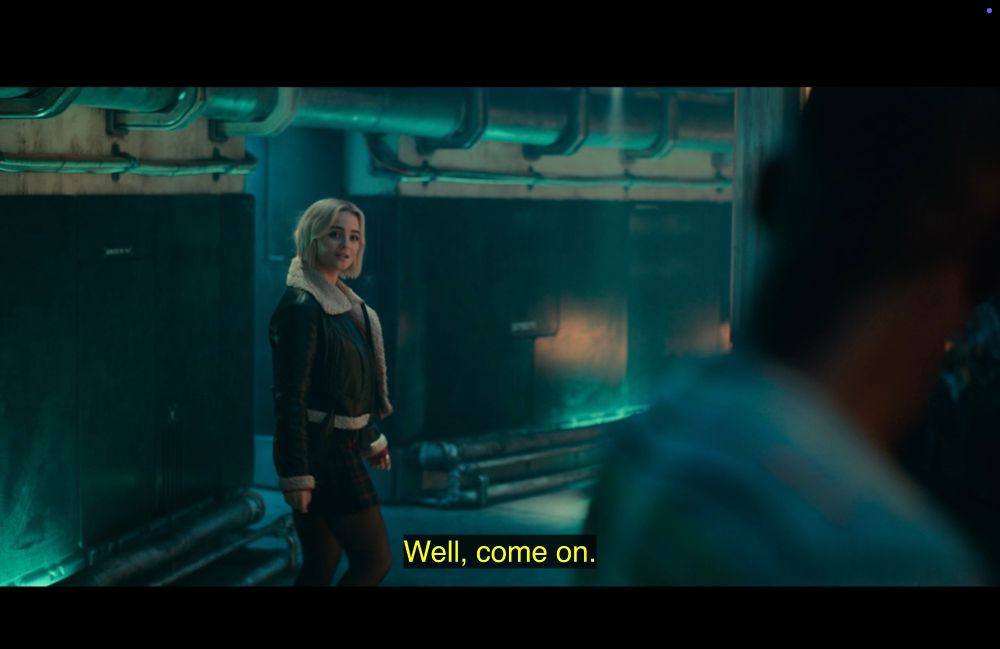 Screen from the English subtitled version of Space Babies. Ruby sets off down a corridor, telling the Doctor, “Well, come on.”