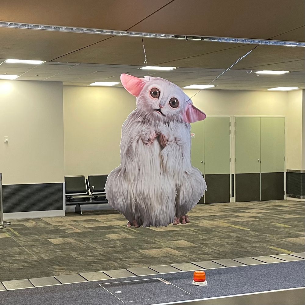 Photo from July 2024 of an advertisement at Wellington Airport which was a life-sized cut out of the Meep from Doctor Who – The Star Beast (2023). 