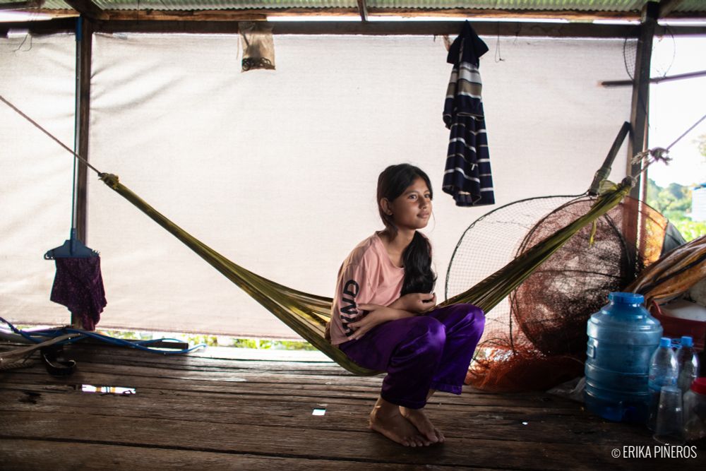 Lisa Yeng, 13, sits in a hammock after her brother Chankoo left their home to prepare for his new life in Korea. “I will miss them very much. But I will stay here and study to become a teacher and help people in my village get a better education.” © Erika Piñeros