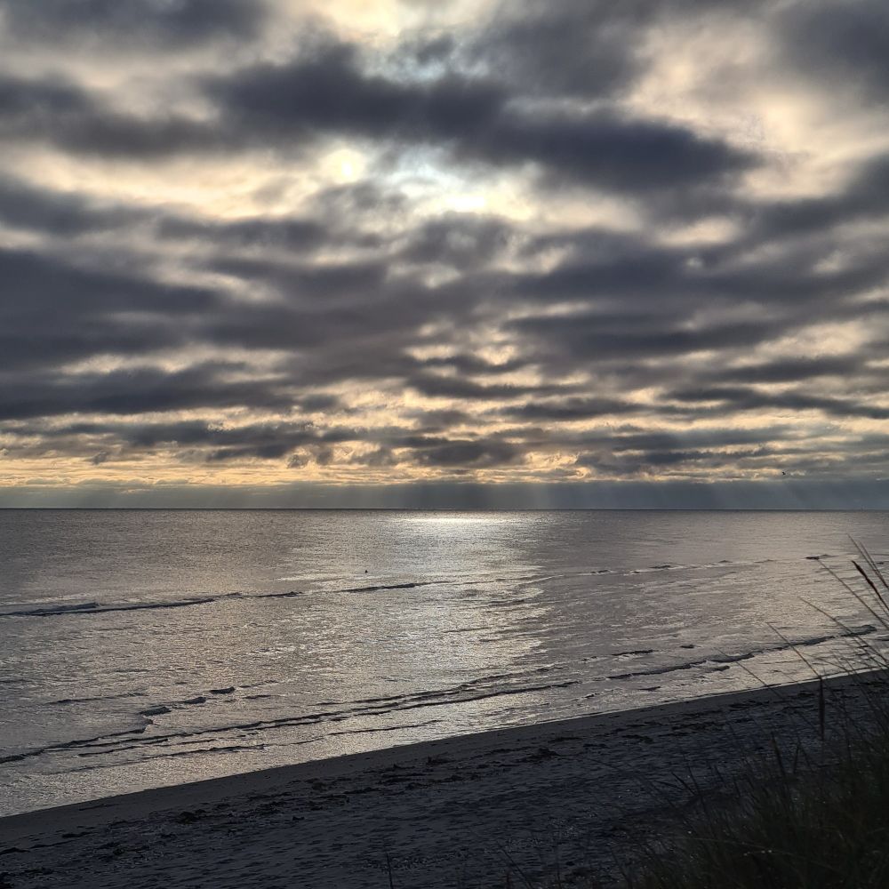 Misty and cloudy sunrise along the coast.