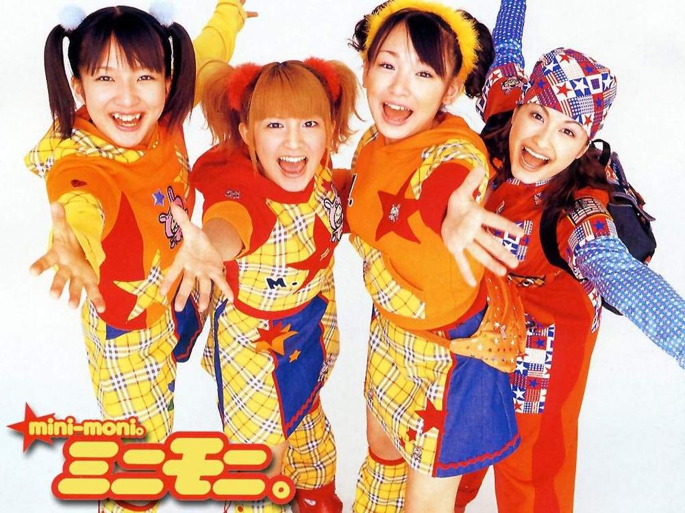 Image of early 2000s J-Pop band Minimoni. Four woman all wearing matching outfits and shouting at the camera.