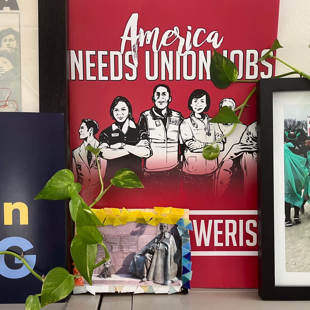 one tendril of a leggy pothos plant reaches up from the lower left (this would be leafy Adam) towards another that reaches down from the upper right (leafy God, obvs)