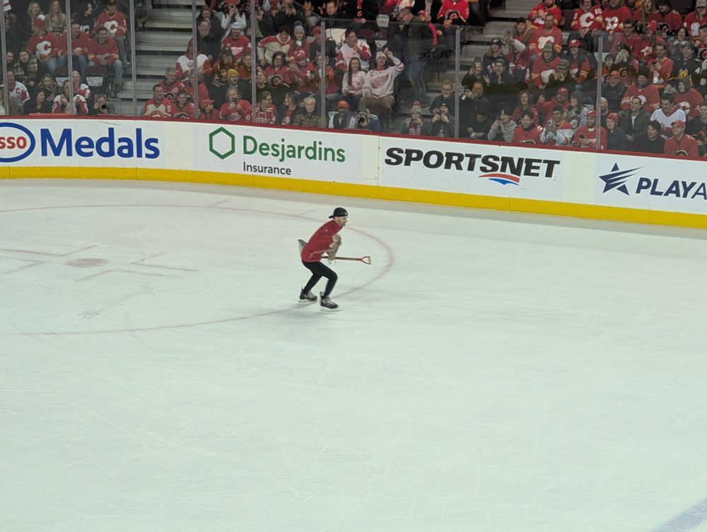 A Calgary ice crew member carries off an octopus