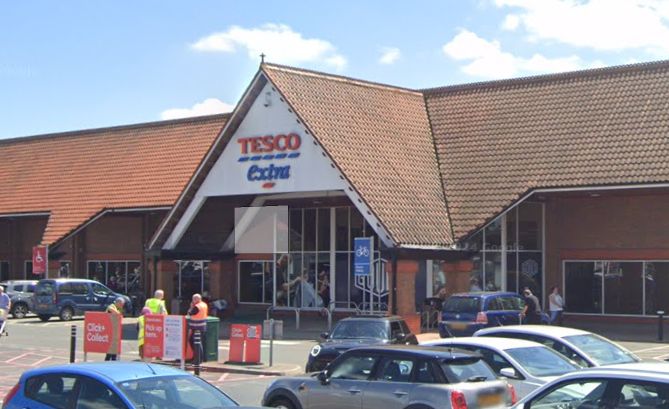 Exterior of a Tesco Extra supermarket, with red-tiled pitched roof. Credit Google Maps.