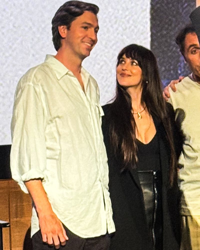 Dakota Johnson looking up at Nicholas Braun
