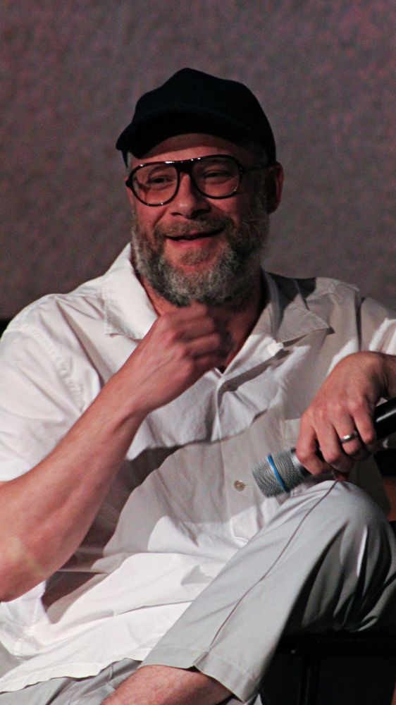 Seth Rogen smiling like he knows he just said something funny