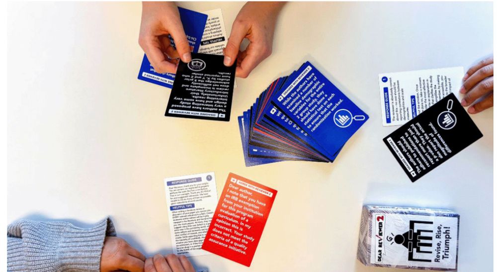 Players reading and playing the card based game - Dear Reviewer 2.