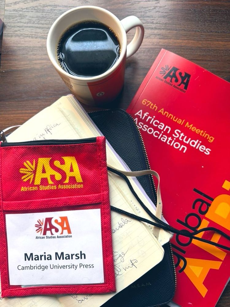 Pic of my desk: includes coffee, note pad, ASA programme and badge 