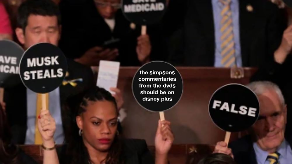 protest sign at the state of the union that reads: the simpsons commentaries from the dvds should be on disney plus