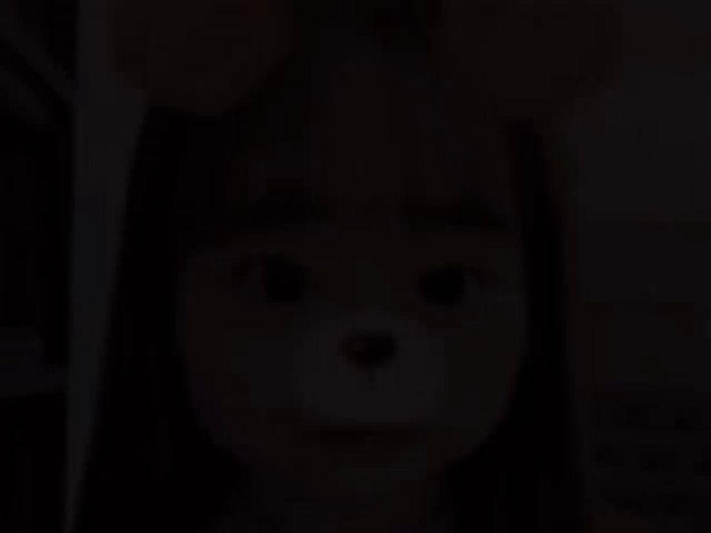 a close up of a little girl wearing a teddy bear mask on her face .