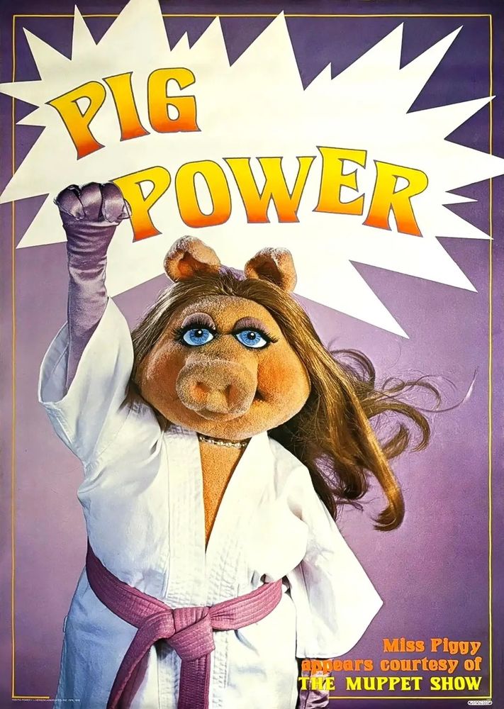 text Pig Power in yellow in a white speech bubble. Purple background 
Photo of Miss Piggy is in a white karate outfit with a purple belt and purple long silk gloves and has her first raised.  text: Miss piggy appears courtesy of the muppet show