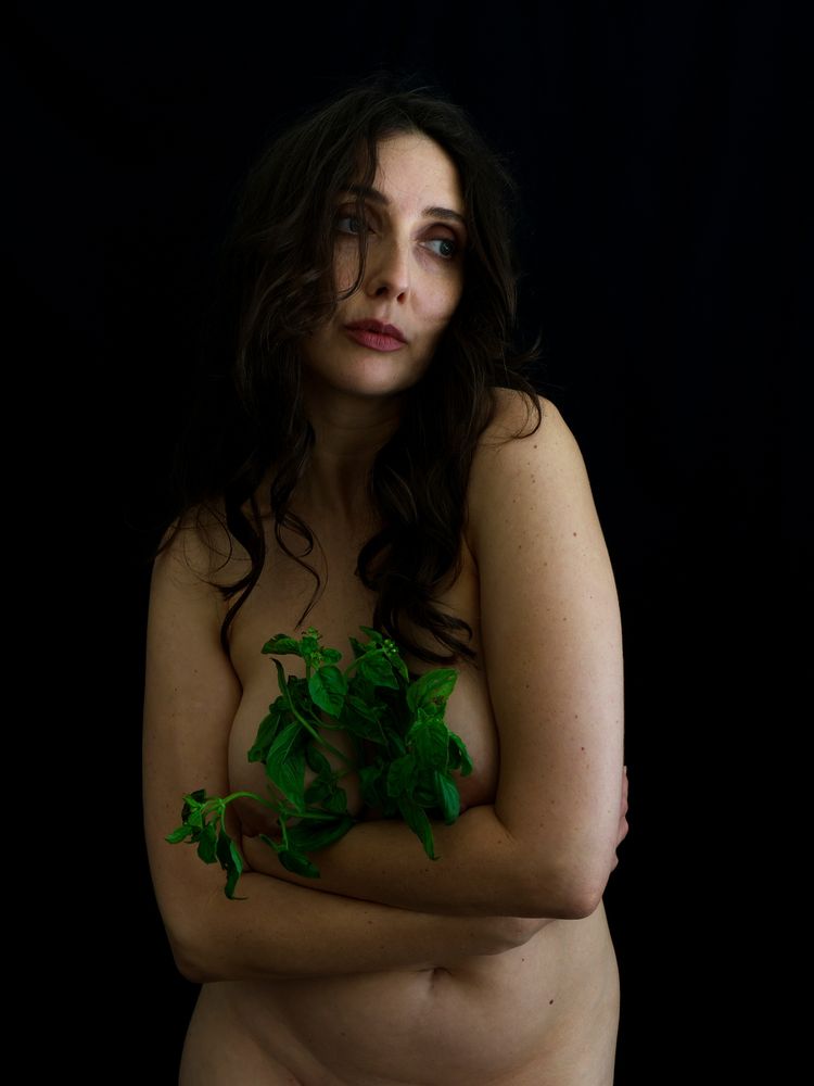 Anoush holding basil on her chest.