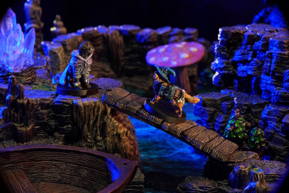 Two dog miniatures facing each other on a bridge in a cavern.