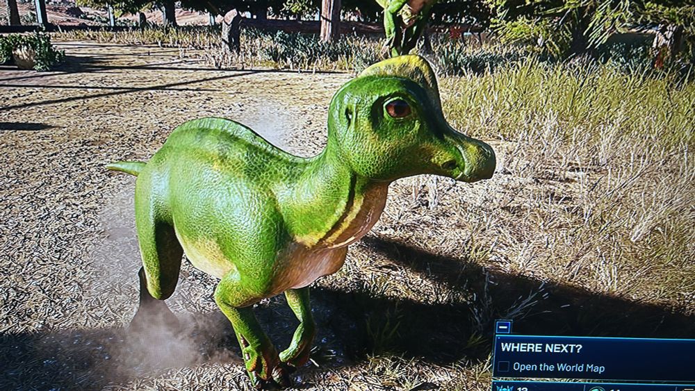A videogame screenshot of a green dinosaur in a sandy desert