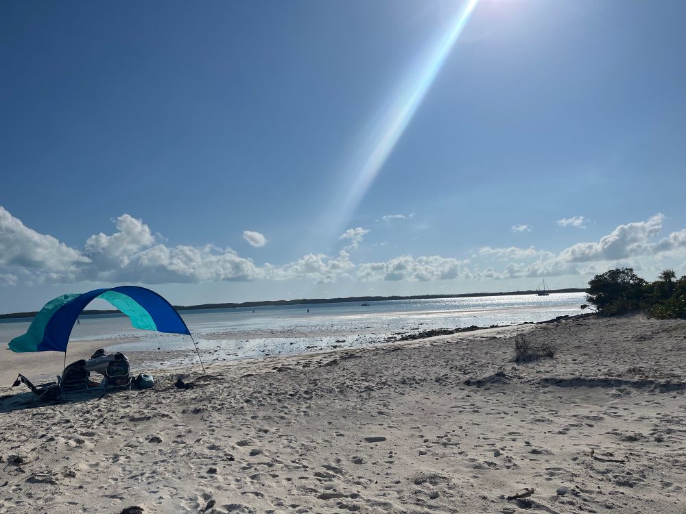 Sun shade set up on sandbar that emerges at low tide.