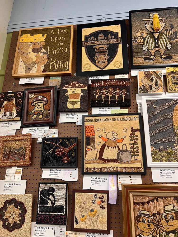 Various pieces  of art on a wall - all created with different grains and beans - celebrating pop culture, art and the MN state fair 