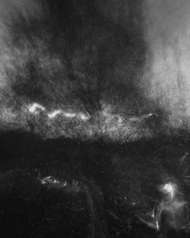 Dark and moody, black-and-white landscape photograph with hand-held lens distortion 

Photography by Al Keddie