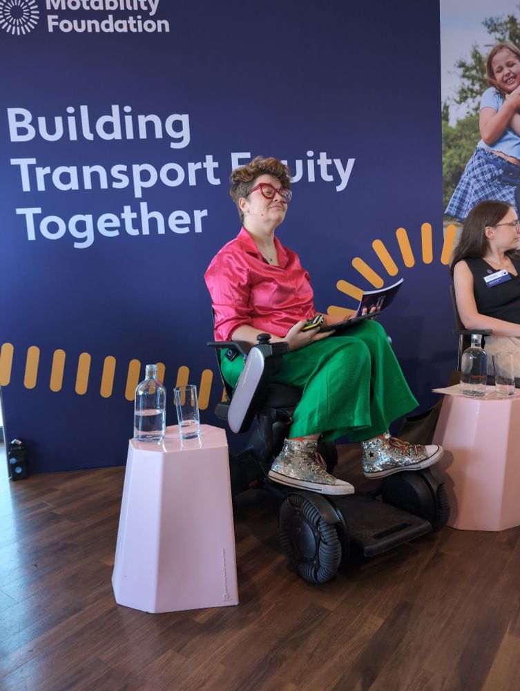 Dr Hannah Barham-Brown in front of Strategy title: Building Transport Equity Together 