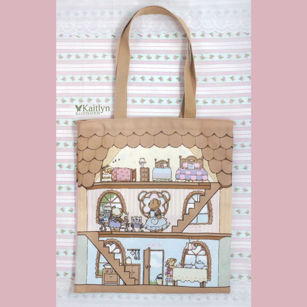 On the back of the tote bag there are 3 floors of the house with the 3 bears looking around and Goldilocks asleep on the smallest bed on the top floor.