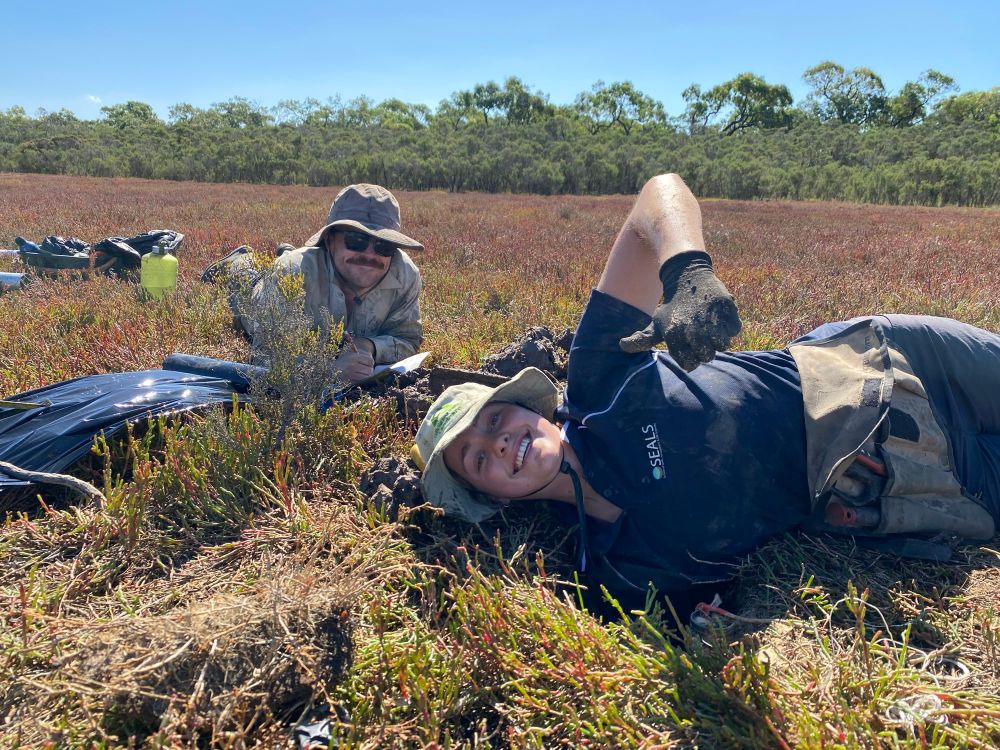 Brooke deep into the tidal marsh sediments but still happy
