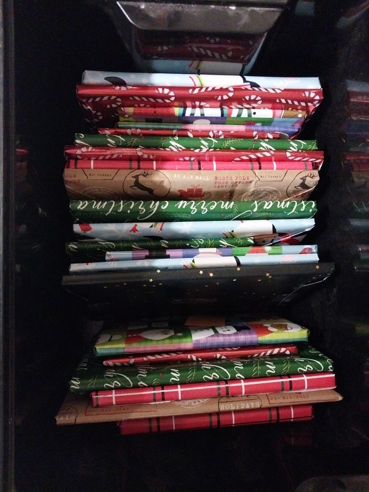 A box of 25 novellas wrapped in varying Christmas designs, individually