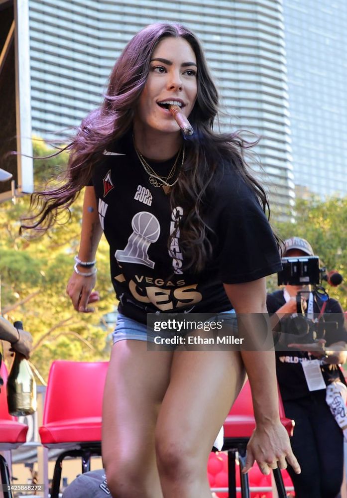 Kelsey posing at some promo event, also with the signature cigar