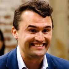 Charlie Kirk, doing that super weird smile of his