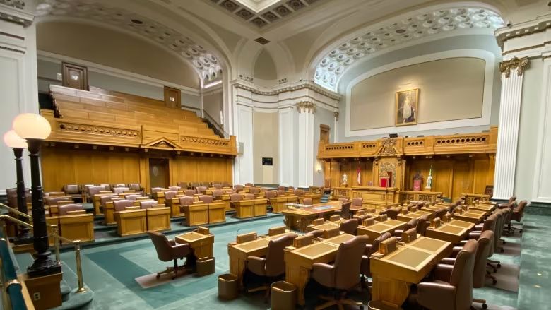 Wooden desks and chairs face each other across the green carpet on the floor of Saskatchewan's legislative assembly. This session, there are 34 government members to 27 Opposition MLAs.