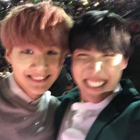 very blurry photo of yoongi and hoseok, closeup on their laughing faces