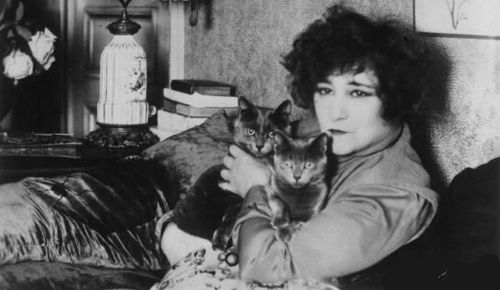Colette, with two cats in her arms